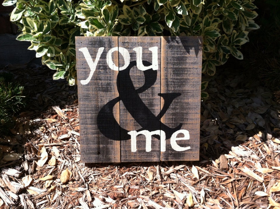 You & Me sign in black and cream paint on a rustic fence picket canvas
