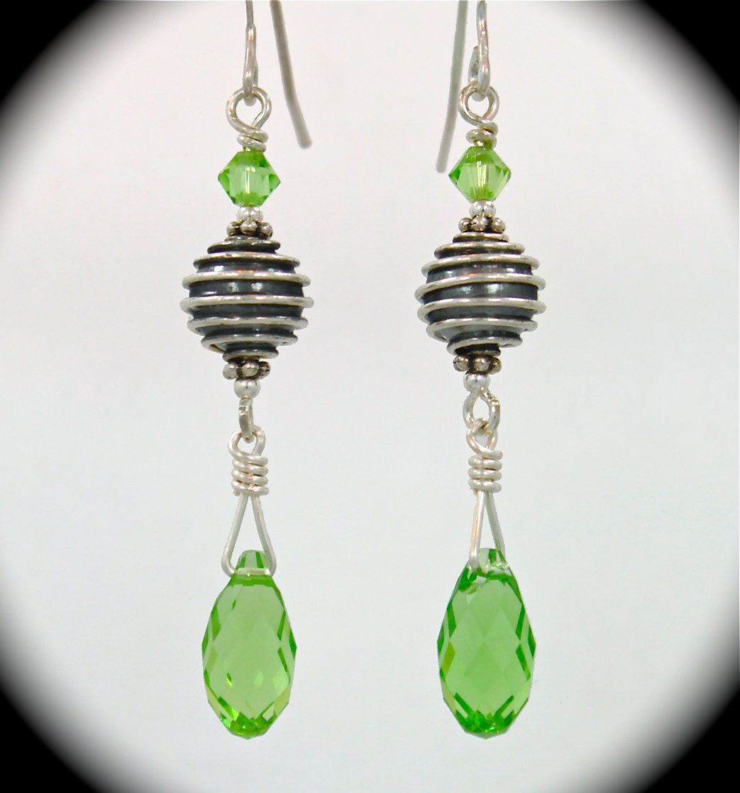 Beautiful Sterling silver earrings with intricate beads and palace green crystal briolettes.