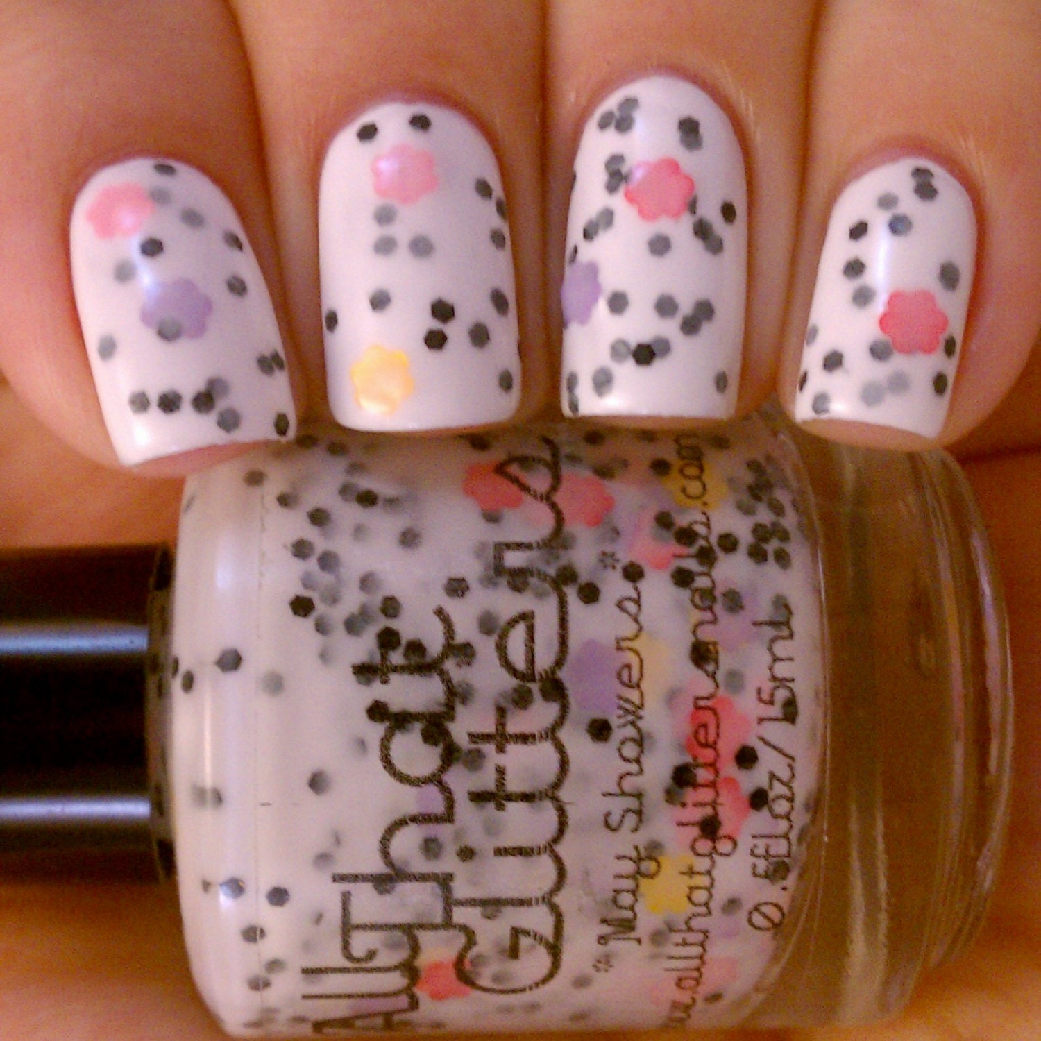 May Flowers - white creme base with pink, purple, red and yellow flowers and black glitter nail polish