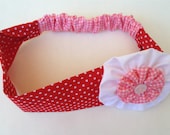 Handmade red and pink headband with coordinated yo-yo fabric flower. Spring celebration gift, girly hair accessory