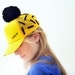 UTHA embroidered yellow trucker hat / cap with black pompom / festival hat