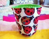 Funky and bright coffee and tea cozies...felt and charms