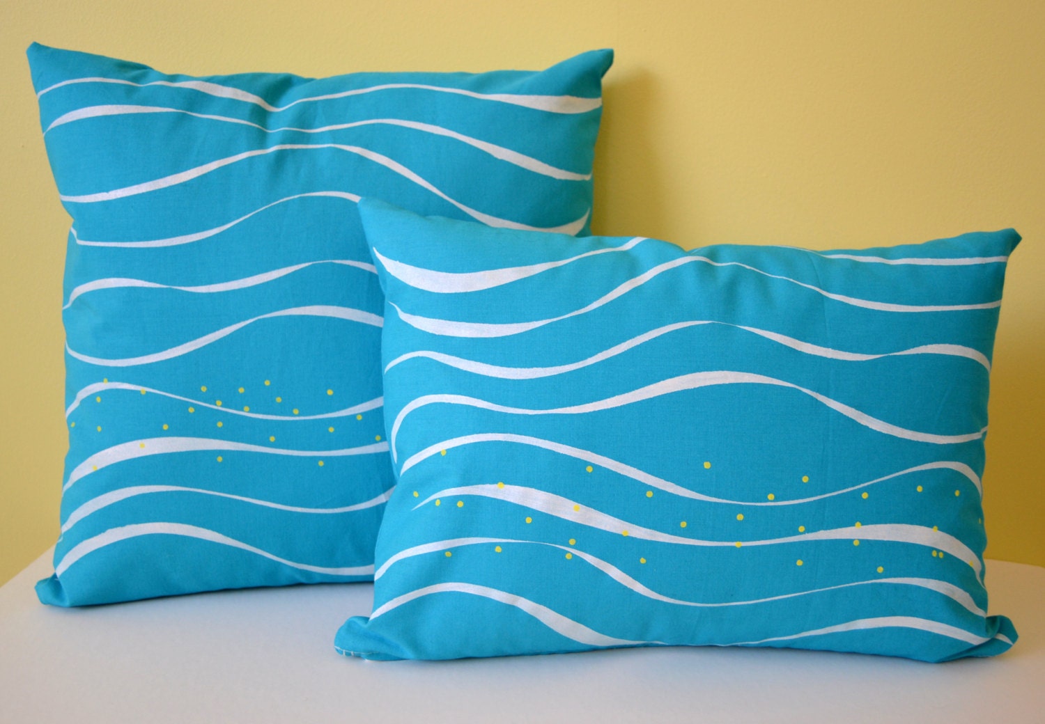 Pair of Hand Printed Pillow Cases in Our Seaside Wave Pattern in white and yellow on Turquoise size 16x16 and 12x16