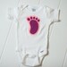 Baby Girl Onesies With a footprint applique.