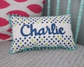 Pillow in navy and chartreuse polka dots. Personalized with name.