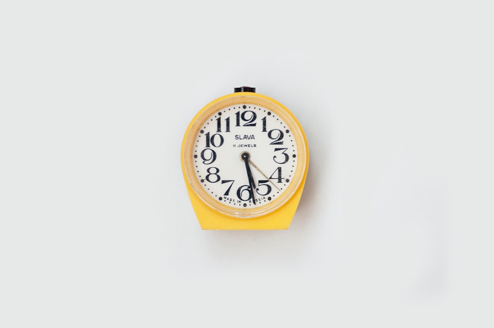 Vintage yellow mechanical alarm clock "Slava"