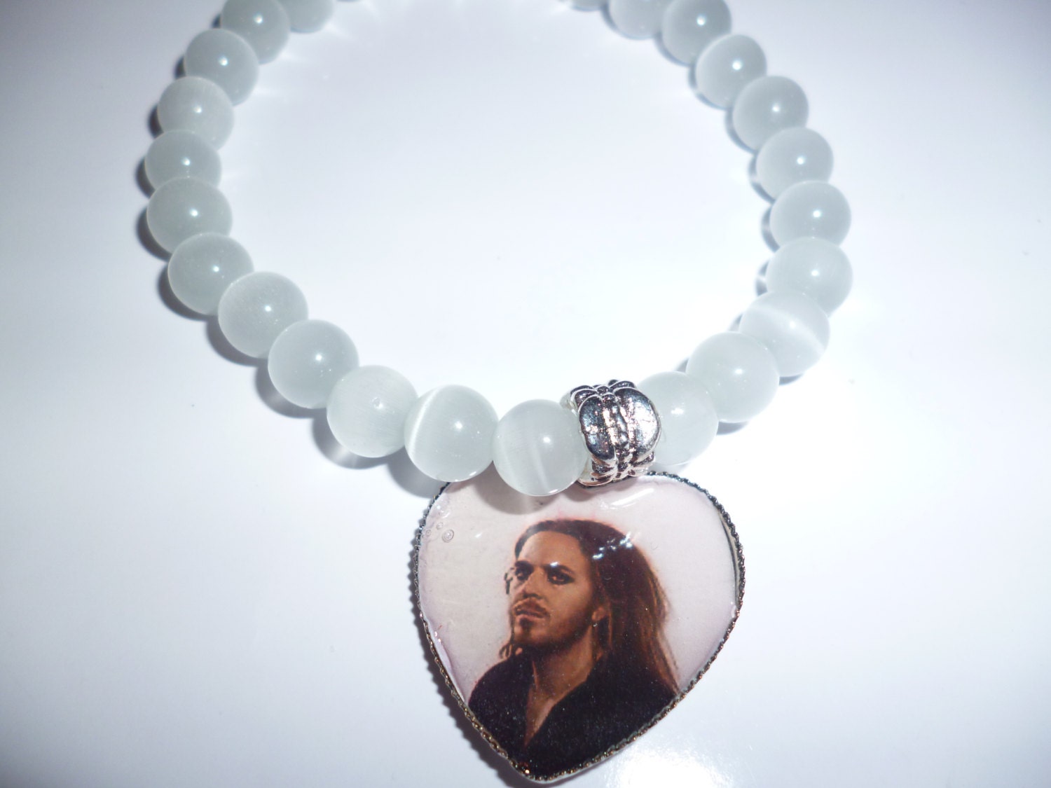 White cat's eye beaded elasticated bracelet with Tim Minchin charm