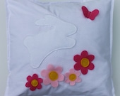 Pretty white with pink spot cushion, decorated with appliqued bunny, flowers and butterfly.