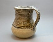 Small pitcher or vase, textured handle, tan and runny grey-black glaze S24