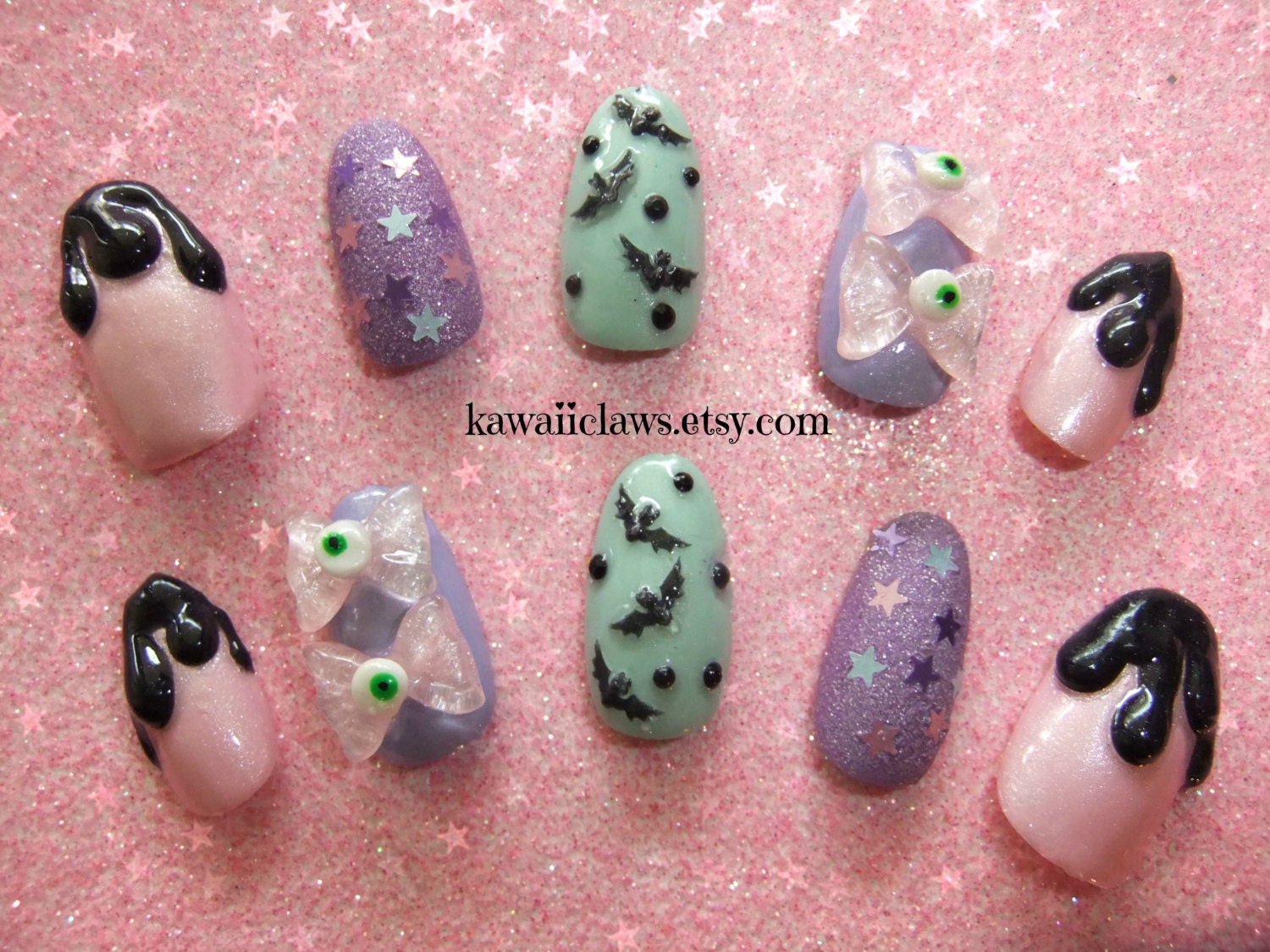 Creepy cute pastel false/fake 3D nails with eyeball bows and bats Japanese nail art kawaii