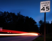 Cars pass by a speed limit sign at night - Long Exposure Photography Fine Art Print or Gallery Wrap Canvas