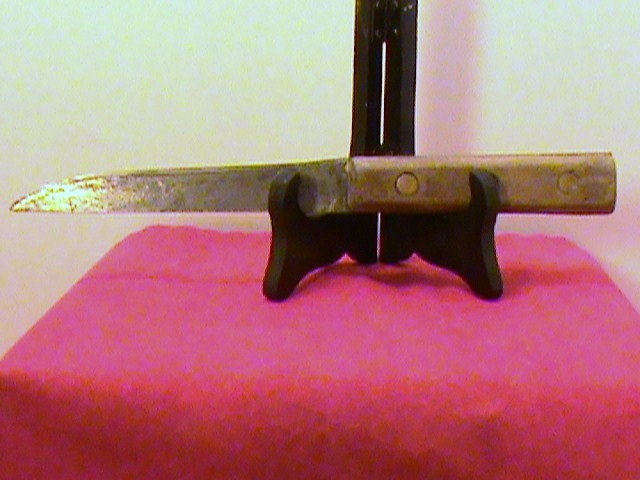 Unbranded butcher knife with a  5 & 3/4 inch carbon steel blade