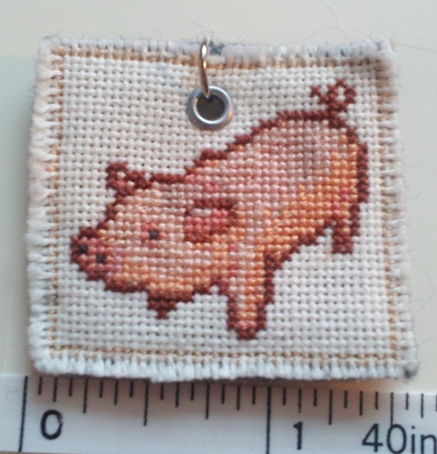 pink piggy cross stitched pendant