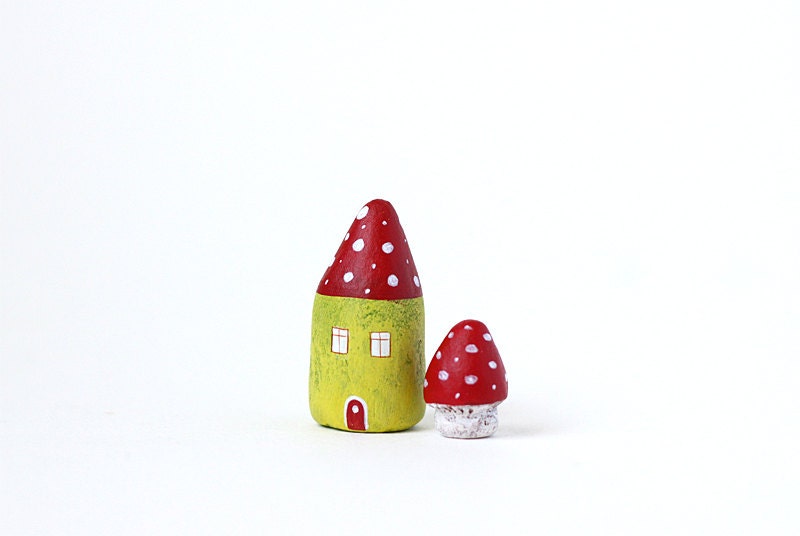 Little green clay house with red roof and white polka dots and a tiny toadstool mushroom