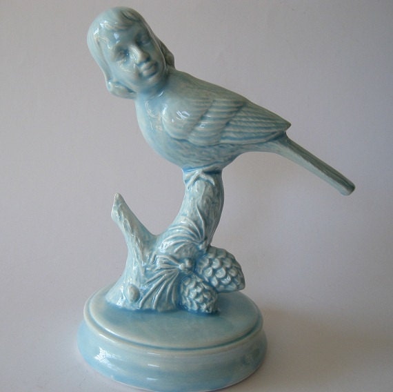 Bird boy on a branch in blue