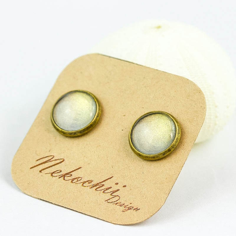 soft cream and golden shimmers ear studs in bronze