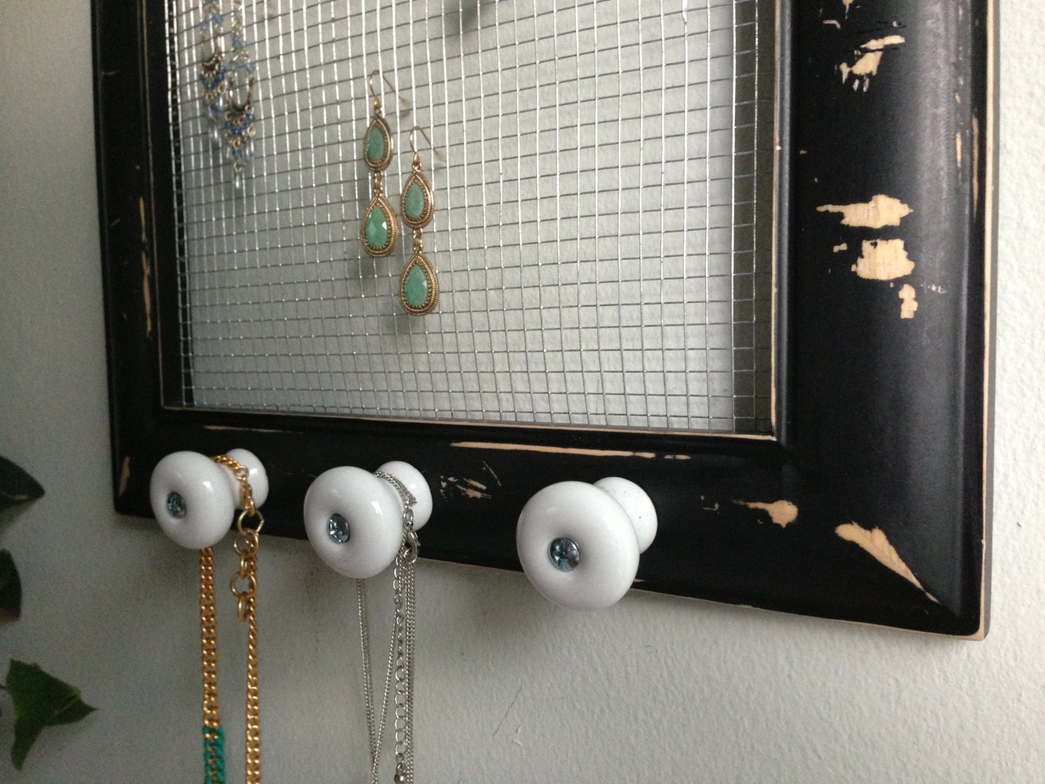 Rugged upcycled black wood frame jewelry holder with white ceramic knobs and silver accents
