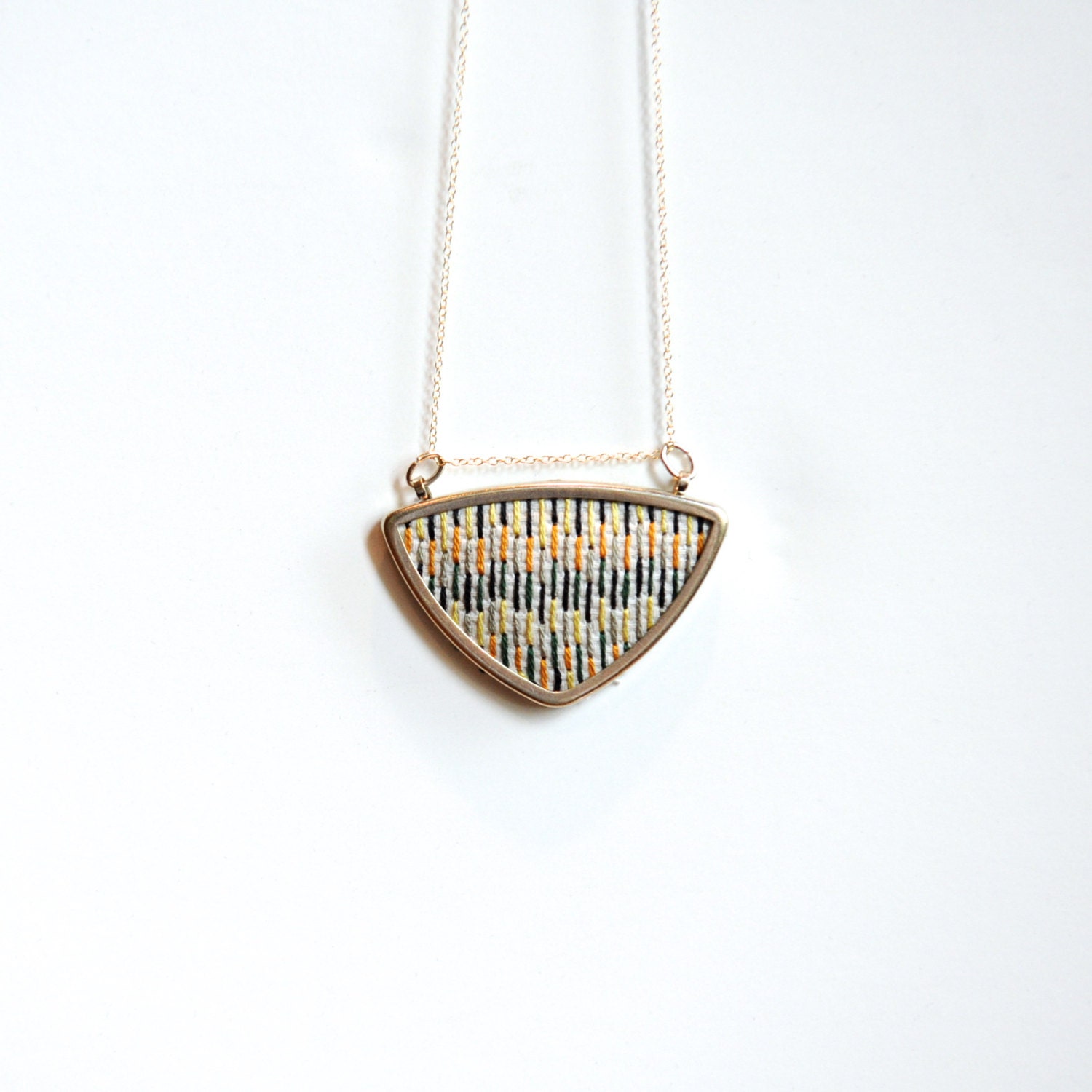 silver geometric triangle necklace // cross stitched x // white orange yellow green grey modern