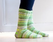 Hand knit socks in durable woolblend yarn in spring green hues, neon green yellow.