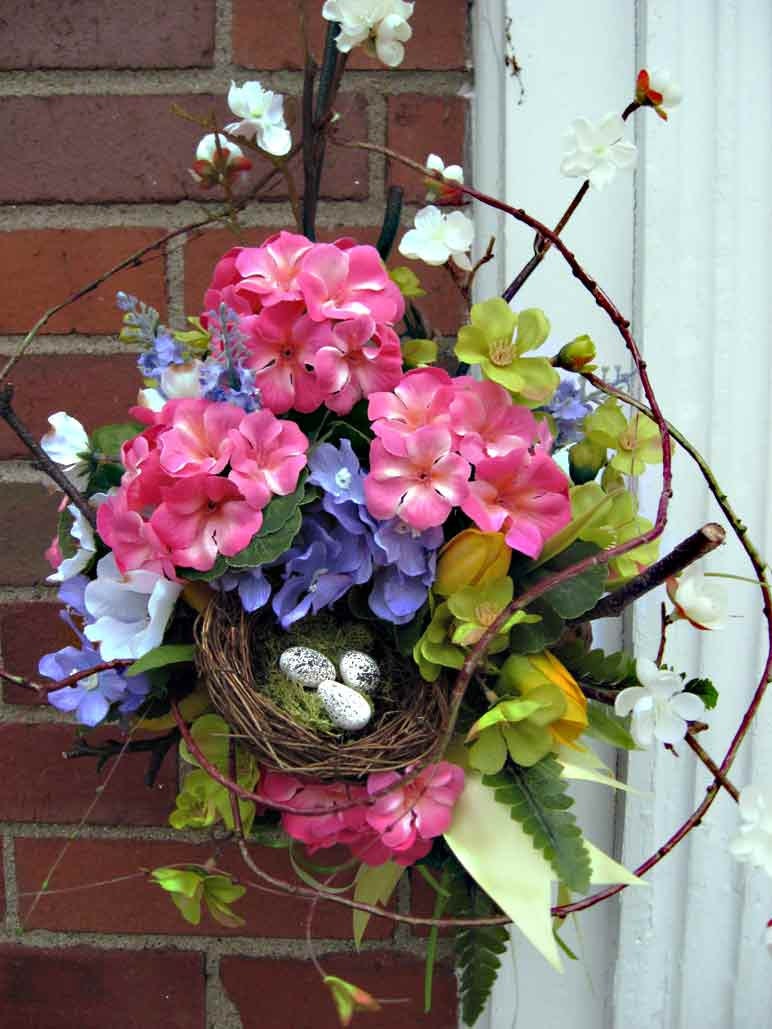 Summer bouquet basket wreath, garden door decoration, door basket with branches, wild vines, nest with eggs, cheery welcome