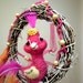 Pink bird nest wreath ornament with pearls and fuchsia feathers