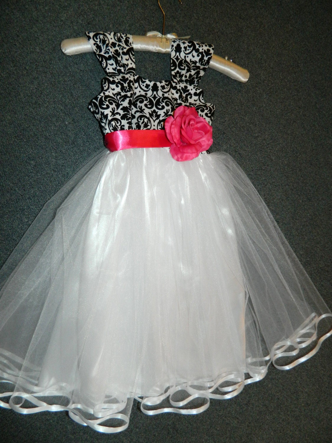 Black and white damask bodice embellished with any color sash/flower attached to billowy white tulle skirt with white satin lining.