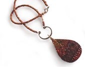 Textural Tribal Pendant Necklace: polymer clay, tear drop shaped, black, orange, yellow, gold, red, beaded