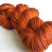 100g superwash sock yarn with nylon, ginger, orange, brown