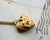 loves photography. camera necklace. gold ox
