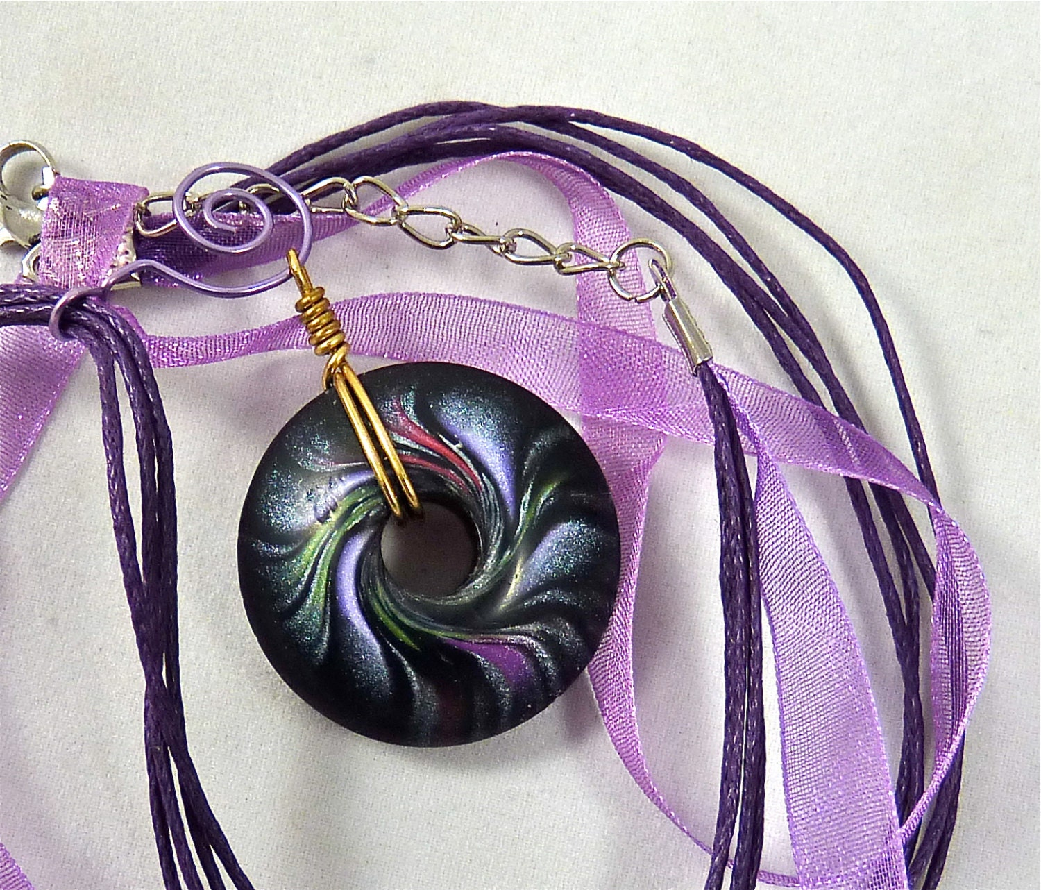Swirl Pendant Made from Polymer Clay in Black with Silver and Purple Shimmer
