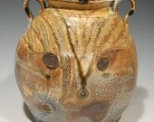 Large wood fired jar with decorative handles.
