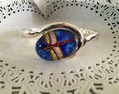 1 beautiful Bracelet with whimsical 1 in round image on the pad. This is a bracelet made of copper and bronze plated.