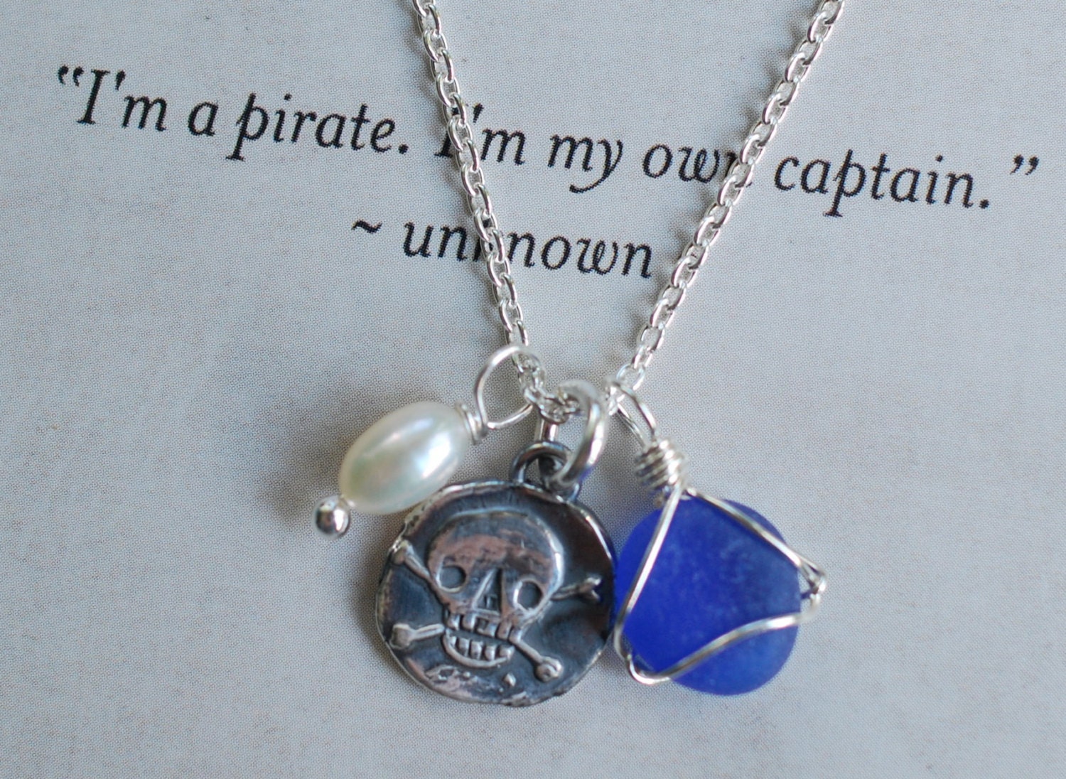 skull and crossbones wax seal necklace with eco friendly seaglass