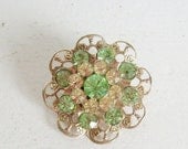 Memorial Day Sale Vintage filigree rhinestone brooch or pin green and gold round