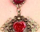 16&1/2' Antique Brass Filigree necklace with an aluminum flower cabochon, in red and champagne. 