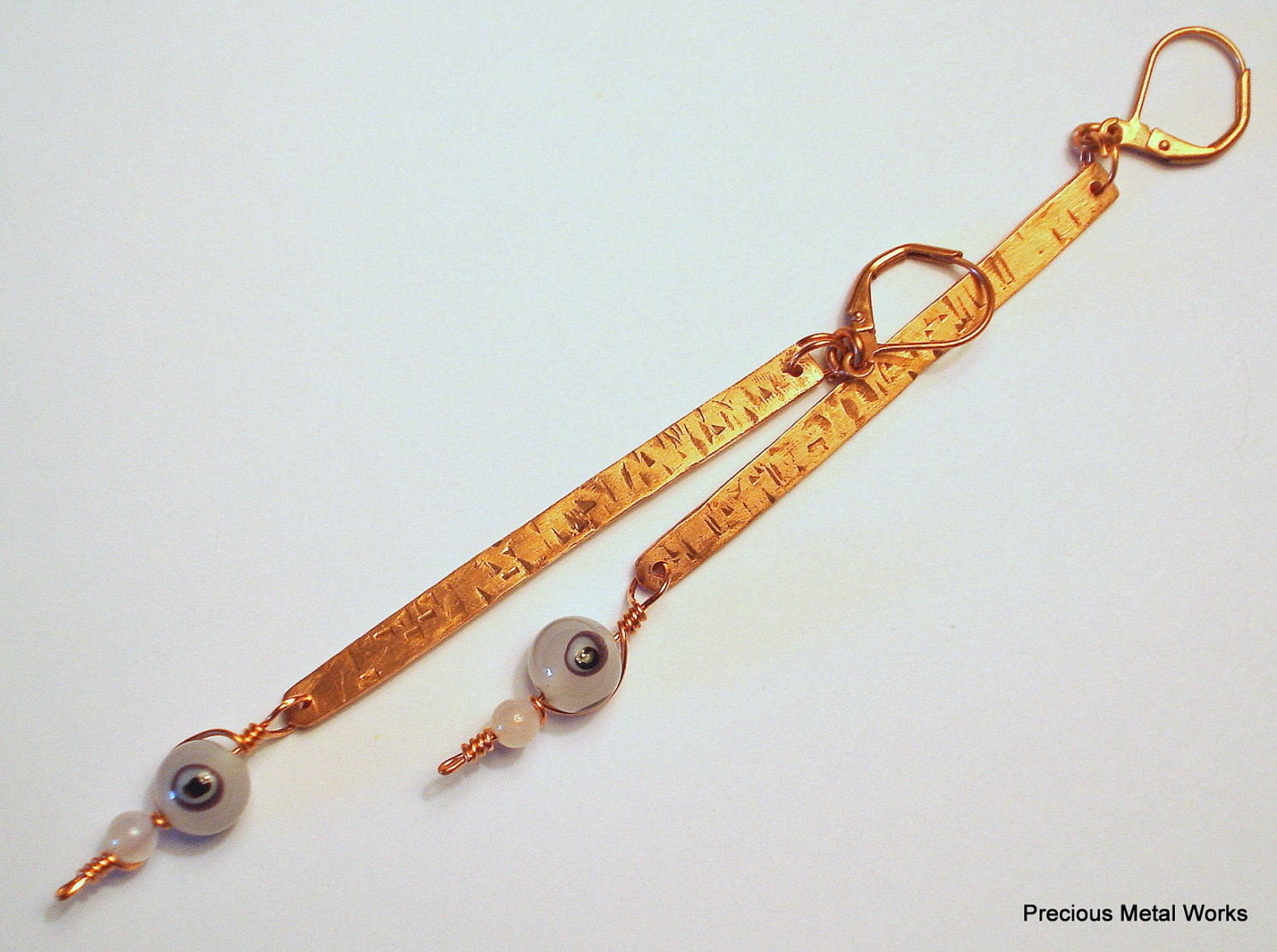 Eye Rock, handmade, textured, copper wire and pale pink, "evil eye", pierced, dangle earrings