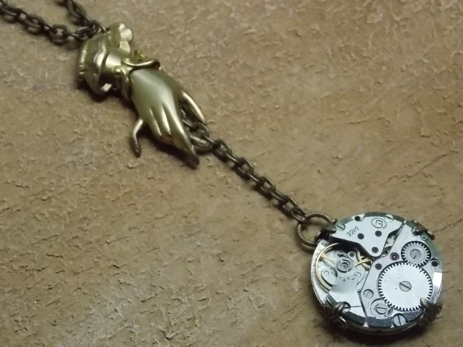Steampunk Necklace Hand Holding a Vintage Watch Movement Clockworks Brass Jewelry