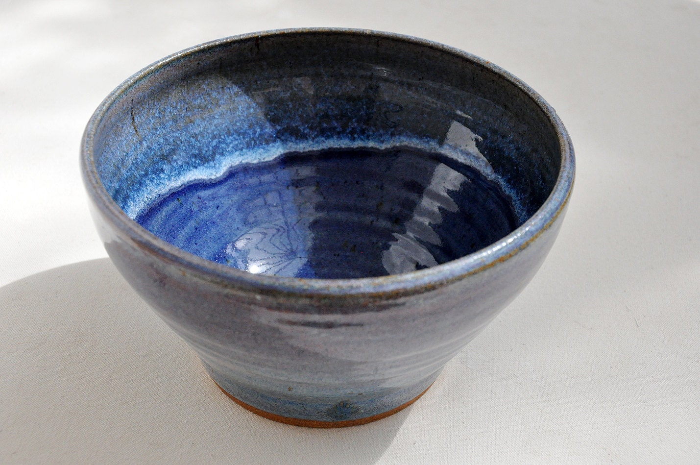 Wheel Thrown Stoneware bowl with blue center and lavender outside.
