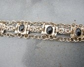 This One of a Kind, Gold Filled and Sterling Silver Chain mail Bracelet has 8X10 mm Bezel Set Black Onyx Cabochons
