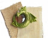 Green dragon pendant pink eyes