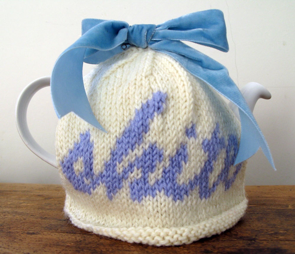 Rude "shite" cream and blue wool tea cosy