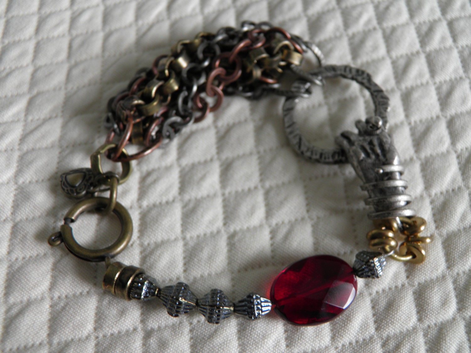 Multi chain bracelet with a metal hand connector charm ......