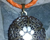 Filigree memory round  locket with lead free pewter paw and orange cord