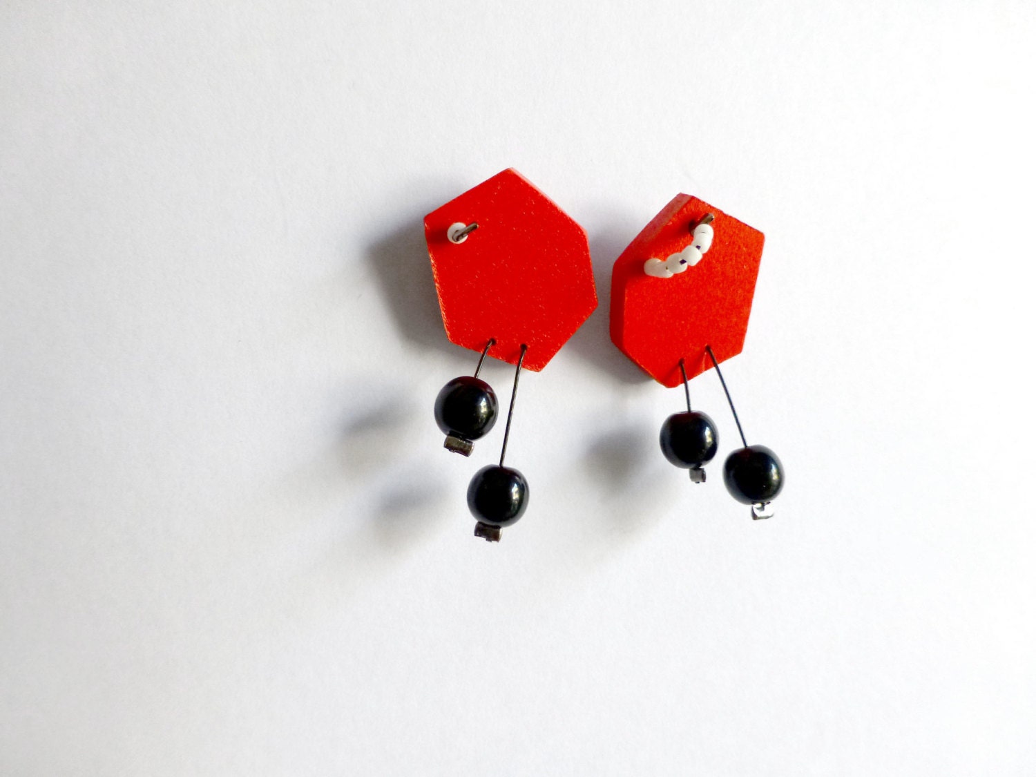 geometric minimal red polygon post earrings with black dots - contemporary jewelry