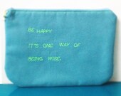 teal zipper pouch with neon green stitched quote - be happy -