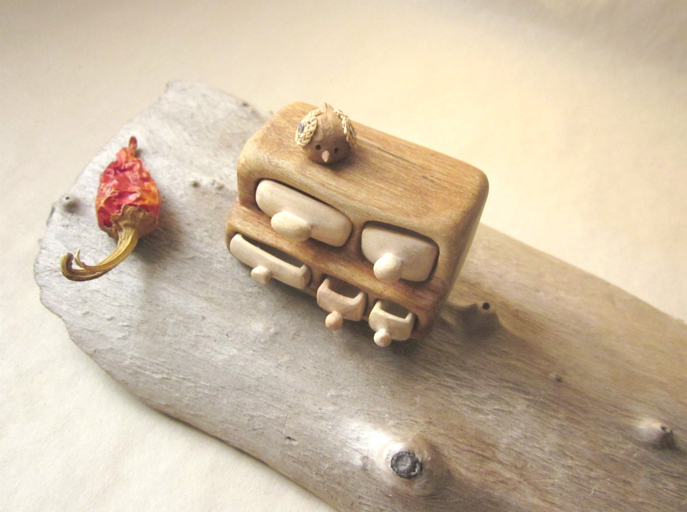Miniature chest of drawers with a small bird