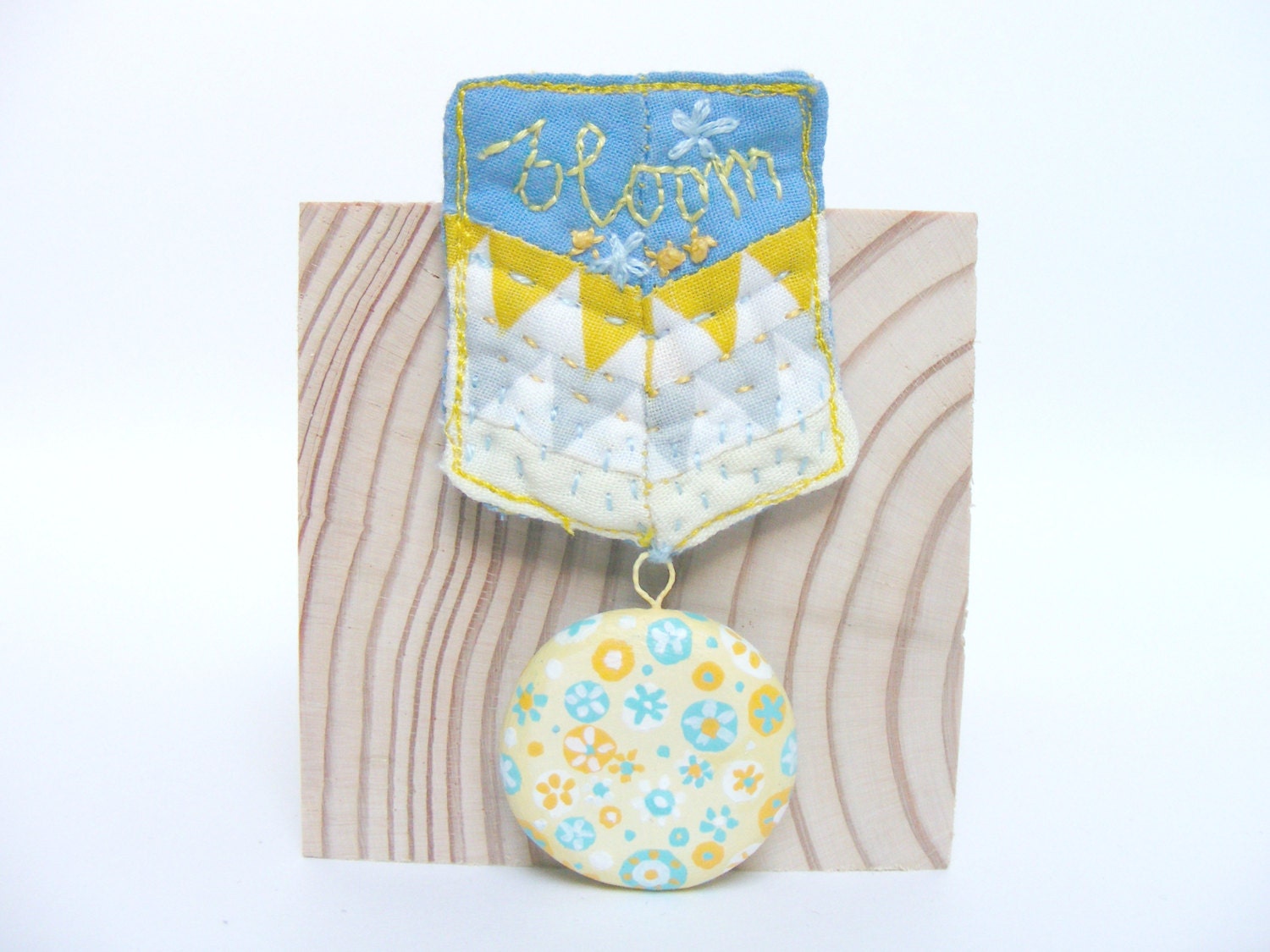 one of a kind - brooch - medal - geometric pattern fabric - hand painted clay piece with flowers- lemon, mustard, grey, turquoise
