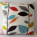 Retro autumn leaves in red, orange, turquoise and green on cream background cushion cover, slip cover, decorative cushion