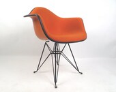 Herman Miller Eames bright orange fiberglass arm chair, free Greyhound shipping in the USA