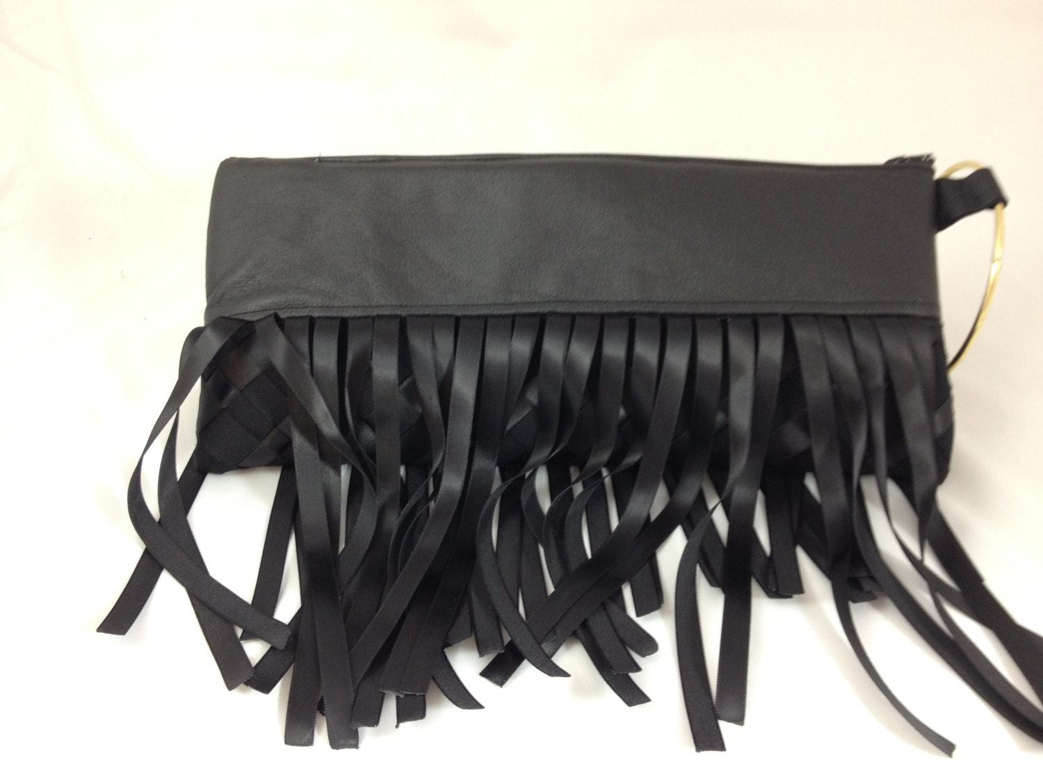 Bangle Clutch in recycled black leather and Fringe ribbon